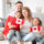 A happy family holding Canadian flags